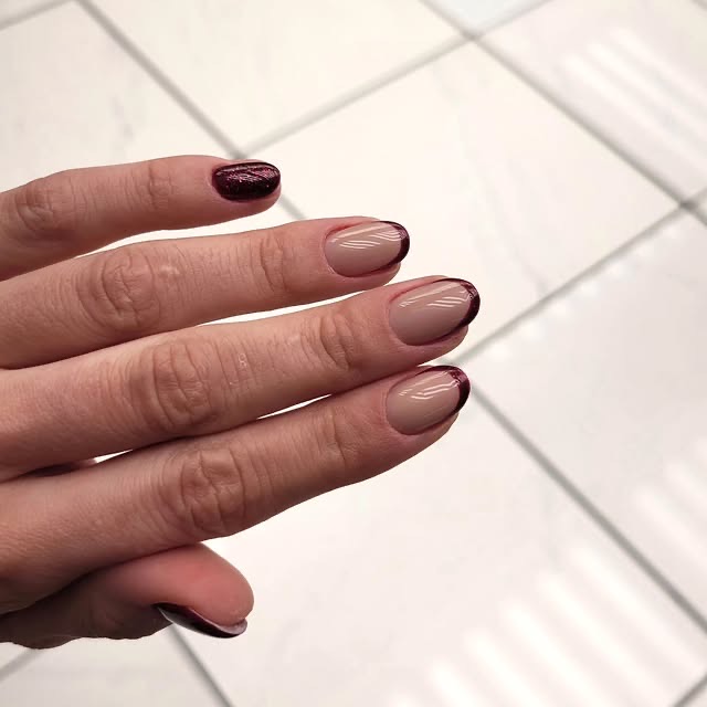 Classic deep red nails on a neutral background