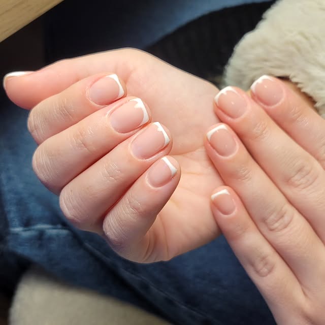 French manicure with clean white tips, close-up